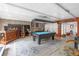Spacious game room featuring a pool table, custom bar area, and cozy seating at 2704 Dorene Dr, Plant City, FL 33563