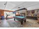 Open game room with pool table, bar, and plenty of space for entertaining and recreation at 2704 Dorene Dr, Plant City, FL 33563