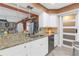 Kitchen featuring white cabinets, granite countertops, breakfast bar and stainless steel appliances at 2704 Dorene Dr, Plant City, FL 33563