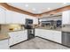 Bright kitchen featuring white cabinets, stainless steel appliances, and beautiful granite countertops at 2704 Dorene Dr, Plant City, FL 33563