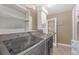 Laundry room featuring a modern washer and dryer, storage shelves, and a glass door at 2704 Dorene Dr, Plant City, FL 33563