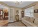 Cozy living room featuring a decorative chandelier, white sofa, and unique decor at 2704 Dorene Dr, Plant City, FL 33563