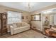 Cozy living room featuring a decorative chandelier, white sofa, and unique decor at 2704 Dorene Dr, Plant City, FL 33563