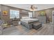 Well-lit main bedroom boasting a decorative ceiling fan, a large bed, and decorative furnishings at 2704 Dorene Dr, Plant City, FL 33563