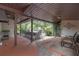 Covered patio with a large table, ample seating, brick flooring, and an outdoor cooking area at 2704 Dorene Dr, Plant City, FL 33563