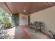 Covered brick patio featuring comfortable seating and garden area, perfect for relaxation and outdoor enjoyment at 2704 Dorene Dr, Plant City, FL 33563