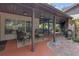 Covered brick patio featuring comfortable seating, decorative rugs, and easy access to indoor living spaces at 2704 Dorene Dr, Plant City, FL 33563