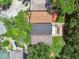 An overhead view of residential rooftops amongst lush greenery, showcasing neighborhood layout and landscaping at 2742 Wilson Ct, Palm Harbor, FL 34684