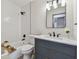 Modern bathroom features a tub, shower with gray vanity, sleek fixtures, and natural light at 2742 Wilson Ct, Palm Harbor, FL 34684