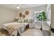 Bright bedroom with neutral tones, decorative wall hangings, and a large window at 2742 Wilson Ct, Palm Harbor, FL 34684