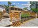 Multi-level wooden deck with lattice railing and flower beds, offering outdoor living space at 2742 Wilson Ct, Palm Harbor, FL 34684