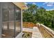Wooden deck with railings, leading down to a lower platform and showcasing lush greenery at 2742 Wilson Ct, Palm Harbor, FL 34684