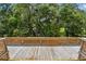 Wooden deck overlooking lush trees, featuring classic railings for a rustic, natural outdoor space at 2742 Wilson Ct, Palm Harbor, FL 34684