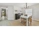 Stylish dining room with modern chandelier, table and seating adjacent to the living spaces at 2742 Wilson Ct, Palm Harbor, FL 34684