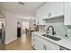 Eat-in kitchen showcasing stainless appliances, white cabinetry, and an adjacent dining area at 2742 Wilson Ct, Palm Harbor, FL 34684