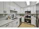Bright kitchen features white cabinets, stainless steel appliances, and modern countertops at 2742 Wilson Ct, Palm Harbor, FL 34684