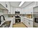 Updated kitchen with white cabinets, stainless appliances, and ample counter space at 2742 Wilson Ct, Palm Harbor, FL 34684