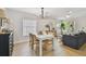 Open-concept living spaces feature a modern chandelier, table and seating, and an abundance of natural light at 2742 Wilson Ct, Palm Harbor, FL 34684