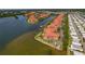 Aerial view of waterfront homes with boat docks, lush landscaping, and community amenities at 2773 Via Cipriani # 1310A, Clearwater, FL 33764