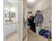 Split view showing a vanity and closet, with neutral tiling and storage solutions at 2773 Via Cipriani # 1310A, Clearwater, FL 33764