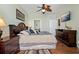Bedroom featuring a bed with nightstands, a dresser, and doors to other rooms at 2773 Via Cipriani # 1310A, Clearwater, FL 33764