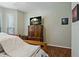 Bedroom featuring a cabinet, a bed, and a large window, creating a cozy ambiance at 2773 Via Cipriani # 1310A, Clearwater, FL 33764