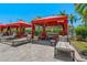 Community cabana area with lounge chairs, side tables, and manicured landscaping at 2773 Via Cipriani # 1310A, Clearwater, FL 33764