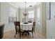 Charming dining area featuring a chandelier, round table, and plenty of natural light from the windows at 2773 Via Cipriani # 1310A, Clearwater, FL 33764