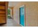 Inviting condo entrance with a bright blue door and well-maintained walkway at 2773 Via Cipriani # 1310A, Clearwater, FL 33764