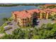 Beautiful condo complex with garages and a waterfront view surrounded by green trees and shrubs at 2773 Via Cipriani # 1310A, Clearwater, FL 33764