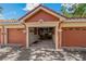 Attached garage with a red tile roof and a peek inside to some storage shelves at 2773 Via Cipriani # 1310A, Clearwater, FL 33764