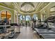 Well-equipped fitness center featuring modern exercise machines and serene views from arched windows at 2773 Via Cipriani # 1310A, Clearwater, FL 33764