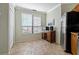 Bright breakfast nook with a large window, wooden cabinet, and stainless steel refrigerator at 2773 Via Cipriani # 1310A, Clearwater, FL 33764