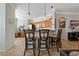 Open kitchen with granite countertops, pendant lighting, and bar seating for casual dining at 2773 Via Cipriani # 1310A, Clearwater, FL 33764