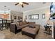 Inviting living room featuring a comfortable brown sectional sofa and stylish decor with ceiling fan at 2773 Via Cipriani # 1310A, Clearwater, FL 33764