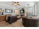 Spacious living room with a fireplace, comfortable seating, and ample natural light from large windows at 2773 Via Cipriani # 1310A, Clearwater, FL 33764