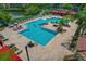 Community pool area with ample seating, lounge chairs, red cabanas, and a well-maintained pool at 2773 Via Cipriani # 1310A, Clearwater, FL 33764