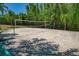 Sandy volleyball court surrounded by lush greenery, offering a relaxing recreational space at 2773 Via Cipriani # 1310A, Clearwater, FL 33764