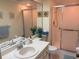 Bathroom featuring double sinks and a walk-in shower at 303 Meadow Ln, Oldsmar, FL 34677