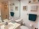 Bright bathroom featuring a shower/tub combo, vanity, and decorative accents at 303 Meadow Ln, Oldsmar, FL 34677