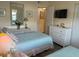 Inviting bedroom with two beds, dresser, and soft, beach-inspired decor at 303 Meadow Ln, Oldsmar, FL 34677