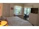 Bedroom featuring a neutral color scheme, plenty of light, and a view to the patio at 303 Meadow Ln, Oldsmar, FL 34677