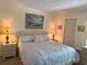 Cozy bedroom featuring a comfortable bed with lamps, and closet space at 303 Meadow Ln, Oldsmar, FL 34677