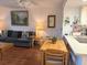 Cozy living area featuring a comfortable couch, wood floors, and bright lighting at 303 Meadow Ln, Oldsmar, FL 34677