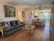 Inviting living room with view to the kitchen and dining area, wood flooring, and cozy furnishings at 303 Meadow Ln, Oldsmar, FL 34677