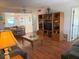 Open-concept living room with wood floors and view to kitchen and dining area at 303 Meadow Ln, Oldsmar, FL 34677