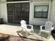 Comfortable patio area perfect for relaxing, with chairs and access to the indoors at 303 Meadow Ln, Oldsmar, FL 34677