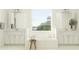 Bright bathroom featuring double vanities, a soaking tub, and a large window for natural light at 31483 Cardinal Yard Dr, San Antonio, FL 33576