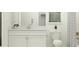 Bright bathroom featuring a single sink vanity with white cabinets, a window, and a shower with decorative curtain at 31561 Cardinal Yard Dr, San Antonio, FL 33576