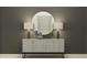 Stylish entryway featuring a patterned console table, a round mirror, and contemporary lamps for a welcoming ambiance at 31561 Cardinal Yard Dr, San Antonio, FL 33576